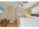 Serene main bedroom featuring wood floors, ample natural light, and direct access to the ensuite bathroom at 815 Greenview Dr, Apollo Beach, FL 33572