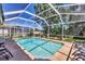 Gorgeous screened-in pool with clear blue water and mature landscaping at 815 Greenview Dr, Apollo Beach, FL 33572