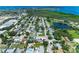 An aerial view showing a residential area with lush greenery, homes with pools, and waterfront access at 8321 43Rd Ave W, Bradenton, FL 34209