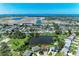 An aerial shot showcasing homes nestled near a serene lake, with a beautiful ocean view in the background at 8321 43Rd Ave W, Bradenton, FL 34209