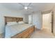 Bright bedroom with a ceiling fan, carpeted floors, and access to the bathroom and hallway at 8321 43Rd Ave W, Bradenton, FL 34209