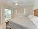 Bedroom with a ceiling fan, sliding glass door, neutral color palette, and natural lighting at 8321 43Rd Ave W, Bradenton, FL 34209
