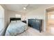 Bedroom with ceiling fan, carpeted floors, a dresser, and an en-suite bathroom at 8321 43Rd Ave W, Bradenton, FL 34209
