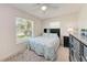 Cozy bedroom with a large window, ceiling fan, rug, and a black dresser at 8321 43Rd Ave W, Bradenton, FL 34209