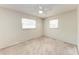 Empty carpeted bedroom with ceiling fan and two windows at 8321 43Rd Ave W, Bradenton, FL 34209