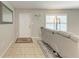 Inviting foyer with neutral tile flooring, a decorative rug and a stylish leather sofa at 8321 43Rd Ave W, Bradenton, FL 34209