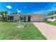 Inviting single-story home with a driveway, lawn, and well-maintained landscaping in front at 8321 43Rd Ave W, Bradenton, FL 34209