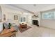 Bright living room featuring a fireplace, tile floors, and access to a patio through sliding glass doors at 8321 43Rd Ave W, Bradenton, FL 34209