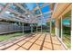 Screened in patio featuring an open structure, tiled floor and nice view of the yard at 8321 43Rd Ave W, Bradenton, FL 34209