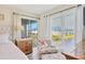 Bright bedroom with a comfortable chair, large window, and sliding door to a screened-in balcony at 840 Audubon Dr, Bradenton, FL 34209
