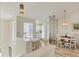 Bright dining area with modern light fixture, wood floors, and adjacent office area at 840 Audubon Dr, Bradenton, FL 34209