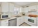 Well-maintained kitchen with white cabinets, stainless appliances, and neutral countertops at 840 Audubon Dr, Bradenton, FL 34209