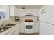 Bright kitchen featuring all-white cabinetry, appliances, and countertops at 840 Audubon Dr, Bradenton, FL 34209