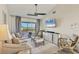 Bright living room with neutral décor, ceiling fan, and sliding glass doors to balcony at 840 Audubon Dr, Bradenton, FL 34209