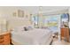 Tranquil main bedroom with bright windows, water views, and a TV at 840 Audubon Dr, Bradenton, FL 34209