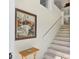 Bright staircase with decorative painting and painting of boats hanging on the wall at 840 Audubon Dr, Bradenton, FL 34209