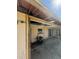 View of the back patio showing it has overhead roofing, sliding glass doors, and items scattered about at 8409 Trionfo Ave, North Port, FL 34287