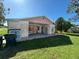 Open backyard with a covered patio area and shelving units at 8409 Trionfo Ave, North Port, FL 34287