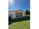 Exterior shot of backyard, with open patio area and yard at 8409 Trionfo Ave, North Port, FL 34287