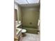 Olive-green full bathroom featuring a standard tub, shower, and a sink with vanity at 8409 Trionfo Ave, North Port, FL 34287