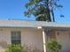 Close-up of a single-story home's facade with a window and a number on the door at 8409 Trionfo Ave, North Port, FL 34287