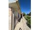 Exterior of the home showing peeling paint, window, and a sidewalk leading to the front entrance at 8409 Trionfo Ave, North Port, FL 34287