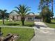Modest single-story home with a palm tree in the front yard and a concrete driveway at 8409 Trionfo Ave, North Port, FL 34287