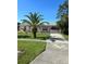 Quaint single-story residence with a palm tree and a concrete driveway at 8409 Trionfo Ave, North Port, FL 34287