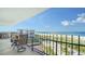 Relaxing balcony with seating and stunning views of the ocean and white sand beach at 1 Benjamin Franklin Dr # 93, Sarasota, FL 34236