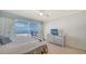 Comfortable bedroom with beach views, white dresser, and ceiling fan at 1 Benjamin Franklin Dr # 93, Sarasota, FL 34236