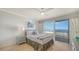 Cozy bedroom with white furnishings and balcony overlooking the beach at 1 Benjamin Franklin Dr # 93, Sarasota, FL 34236