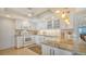 Well-lit kitchen featuring custom cabinets, modern appliances, and granite countertops at 1 Benjamin Franklin Dr # 93, Sarasota, FL 34236