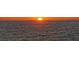 Sun setting over ocean, creating a brilliant orange glow across the horizon at 1 Benjamin Franklin Dr # 93, Sarasota, FL 34236