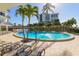 Gorgeous pool area with lounge chairs, palm trees and view of the Condo tower at 1 Benjamin Franklin Dr # 93, Sarasota, FL 34236