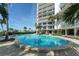 Large swimming pool surrounded by lounge chairs and landscaping at 1 Benjamin Franklin Dr # 93, Sarasota, FL 34236