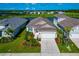 Beautiful aerial view of home with a two car garage, lovely landscaping and lake views at 10177 Crystal Isle Cir, Sarasota, FL 34241