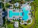 Aerial view of a luxury community pool with lounge areas, lush gardens, and a tranquil setting at 10177 Crystal Isle Cir, Sarasota, FL 34241