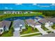 Aerial view of neighborhood with pond showing attractive homes and landscaping at 10177 Crystal Isle Cir, Sarasota, FL 34241