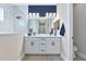 Modern bathroom with double vanity, white cabinets, stylish fixtures, and frameless glass shower at 10177 Crystal Isle Cir, Sarasota, FL 34241
