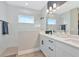 Beautiful bathroom features a double vanity, sleek fixtures, glass-enclosed shower, and bright lighting at 10177 Crystal Isle Cir, Sarasota, FL 34241