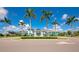 Attractive clubhouse framed by palm trees, offering a welcoming entrance and well-maintained landscaping at 10177 Crystal Isle Cir, Sarasota, FL 34241