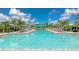 Stunning community pool featuring lounge chairs and shade canopies for residents to relax by the crystal-clear water at 10177 Crystal Isle Cir, Sarasota, FL 34241