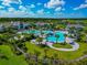 Picturesque community pool area with lounge chairs, sunshades, and lush greenery, offering a resort-style experience at 10177 Crystal Isle Cir, Sarasota, FL 34241