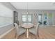 Light-filled dining room features a round table, stylish chairs, and modern light fixture and sliding glass doors at 10177 Crystal Isle Cir, Sarasota, FL 34241