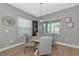 Cozy dining room with round table, four chairs, decorative wall art, and natural light from window at 10177 Crystal Isle Cir, Sarasota, FL 34241