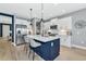 Beautiful kitchen with white cabinets, a blue island, and wood-look tile flooring at 10177 Crystal Isle Cir, Sarasota, FL 34241