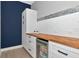 Kitchenette area with white cabinets, wood countertop, and beverage cooler at 10177 Crystal Isle Cir, Sarasota, FL 34241