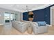 Comfortable living room showcasing contemporary design, light gray couches, and access to patio at 10177 Crystal Isle Cir, Sarasota, FL 34241
