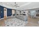 Open-concept living room with modern decor and eat-in kitchen featuring stainless appliances and a blue island at 10177 Crystal Isle Cir, Sarasota, FL 34241