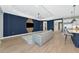 Spacious living room showcasing a modern design with tile flooring, and blue accent wall at 10177 Crystal Isle Cir, Sarasota, FL 34241